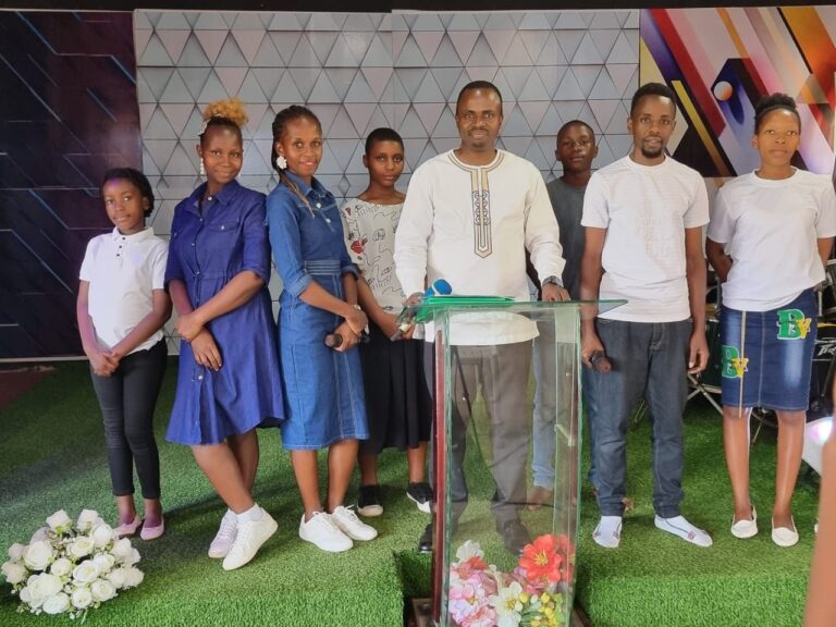 Young people of Tusubira Global Ministries standing together at the pulpit